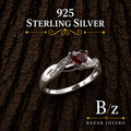 925 Sterling Silver Heart Garnet CZ Ring on bark background