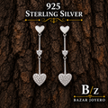 925 sterling silver double heart dangle earrings with clear cubic zirconia details, front product view.