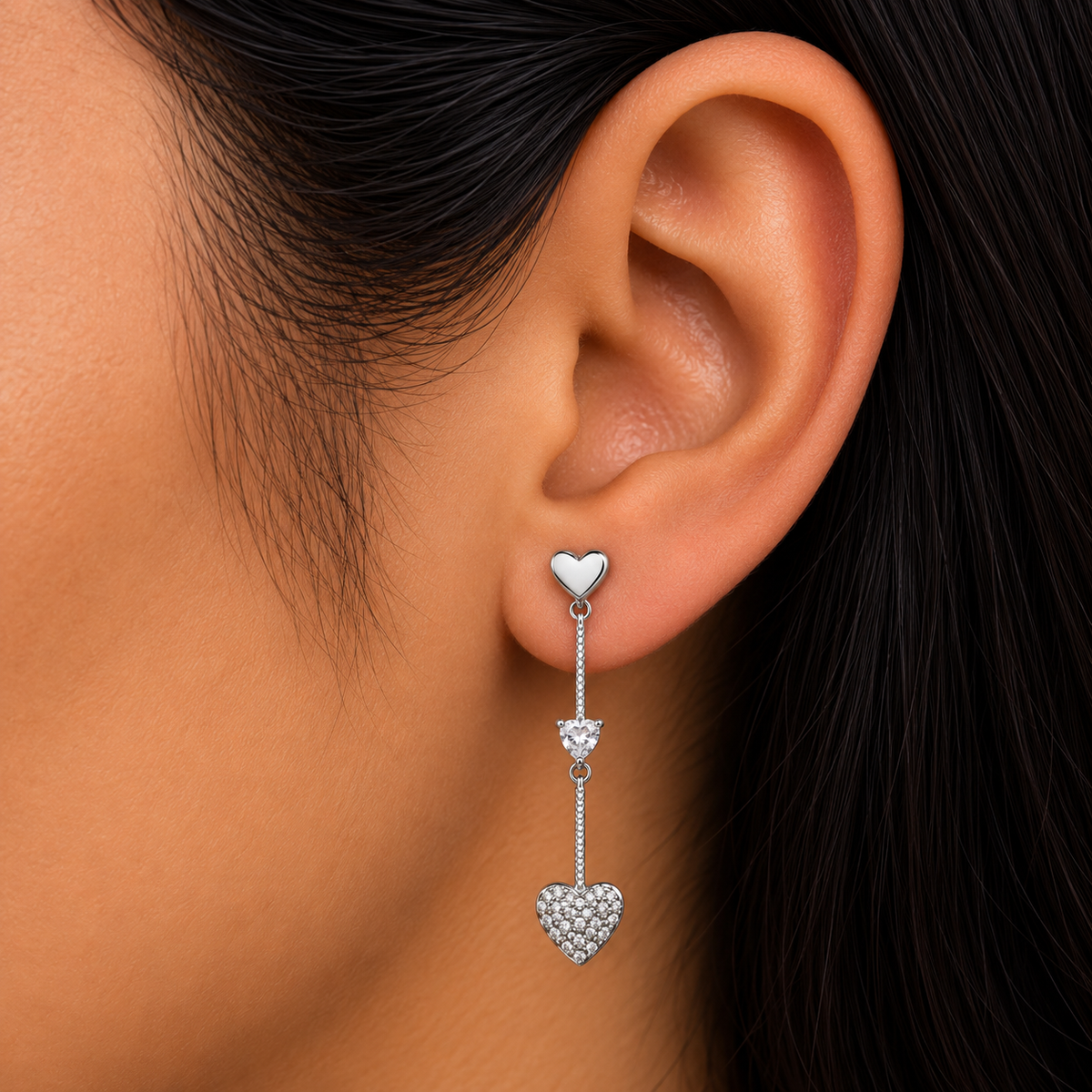 Model wearing 925 sterling silver double heart dangle earrings with clear cubic zirconia accents.