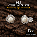 925 sterling silver pearl and CZ swirl stud earrings, detailed front product view.
