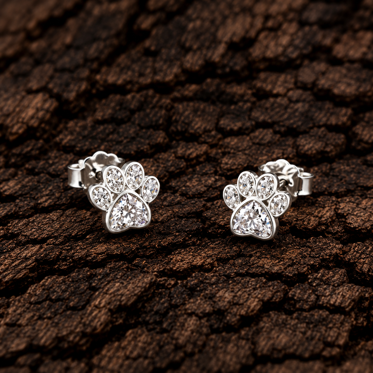 Paw print 925 sterling silver stud earrings with sparkling cubic zirconia stones.