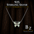925 Sterling Silver White Lab Opal Butterfly Necklace on dark wood background