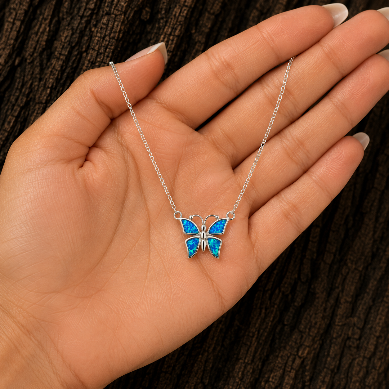 Blue Lab Opal Butterfly Necklace in Hand Showing Size