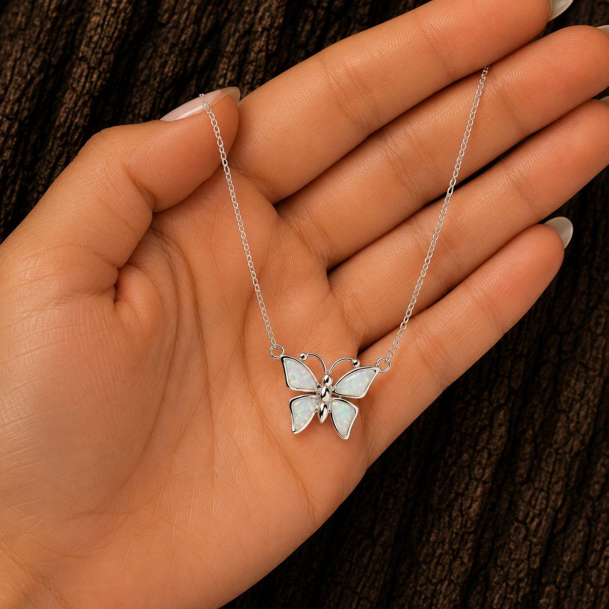 925 Sterling Silver White Lab Opal Butterfly Necklace shown in hand for size reference