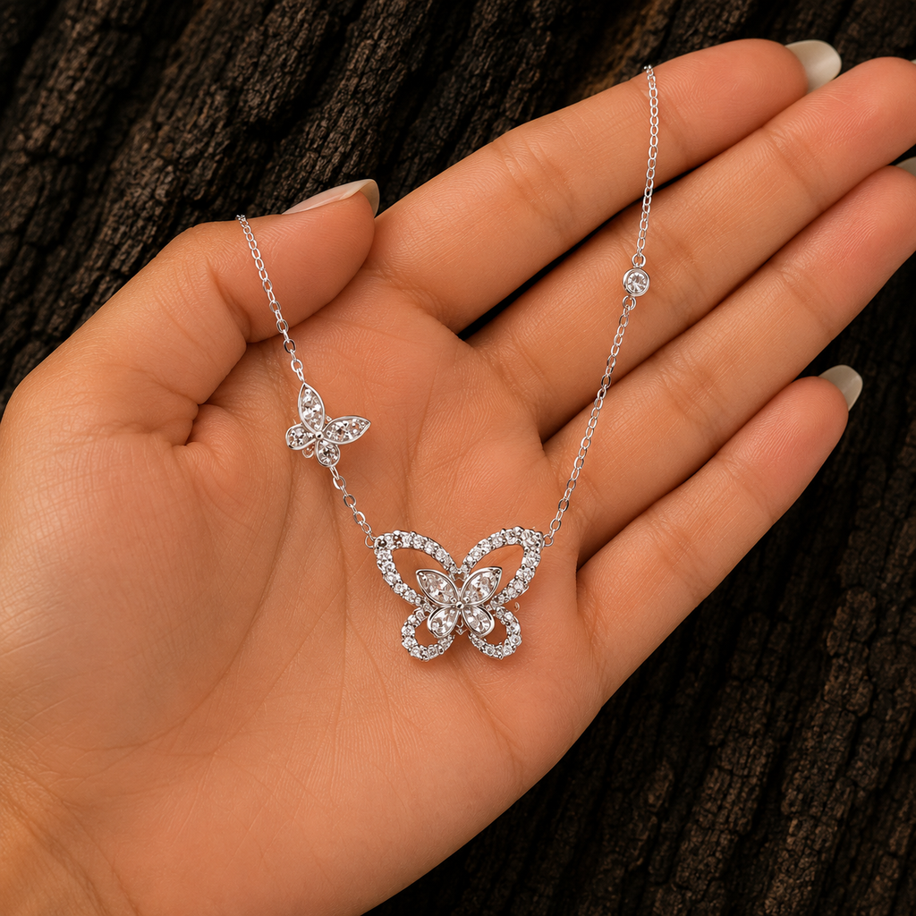 Double Butterfly Sterling Silver Necklace shown in hand for size reference