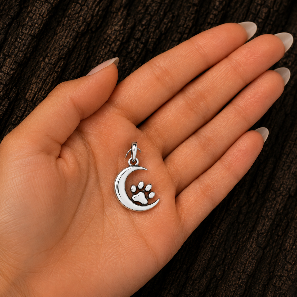 Sterling Silver Moon and Paw Print Pendant shown in hand for size reference