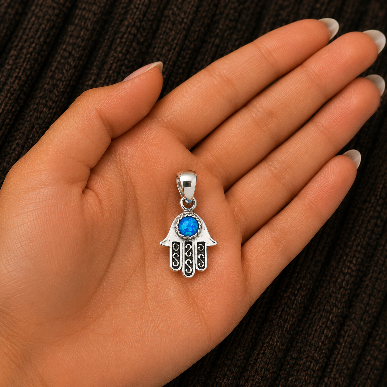 925 Sterling Silver Blue Lab Opal Hamsa Hand Pendant shown in hand for size reference