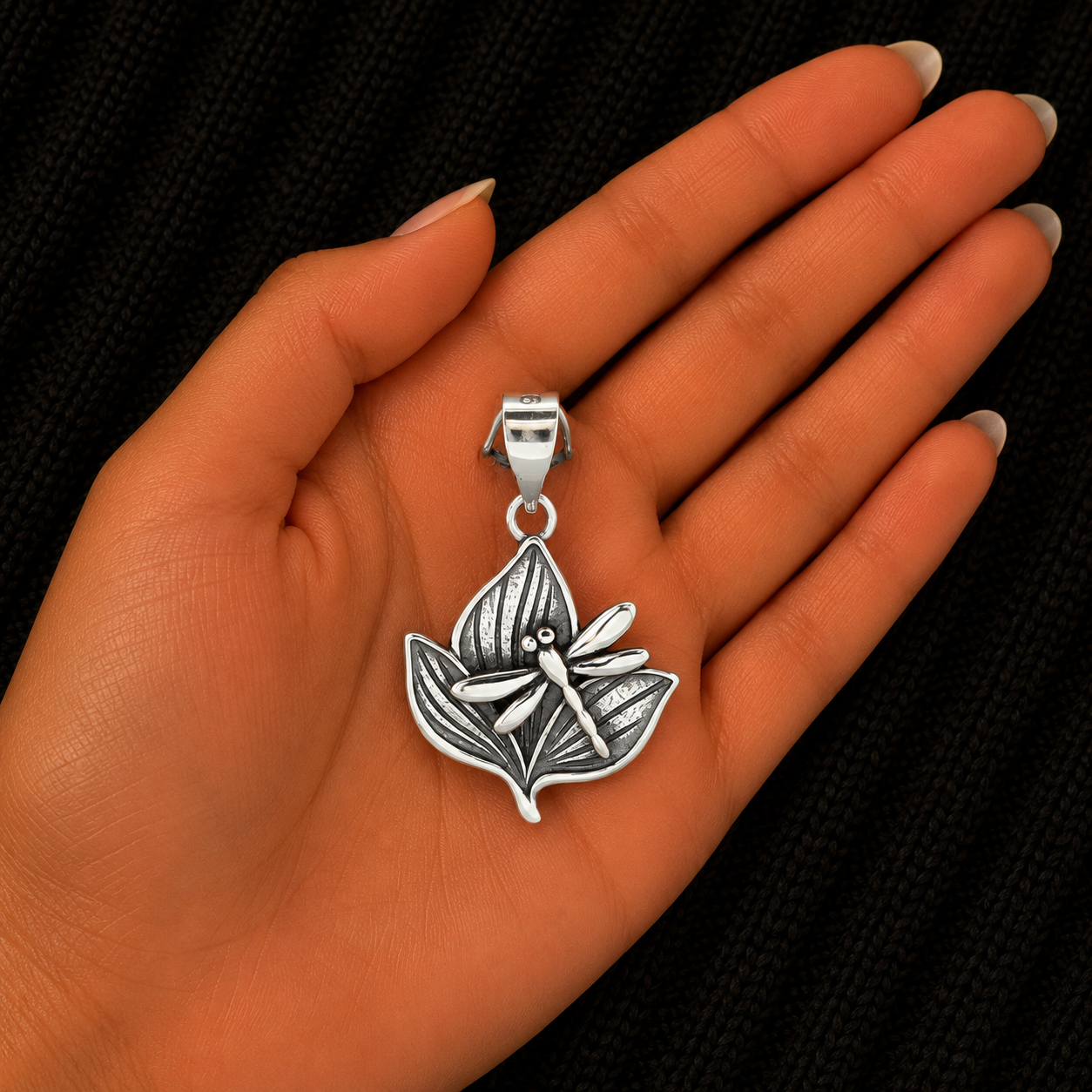 925 Sterling Silver Dragonfly and Leaves Pendant shown in hand for size reference