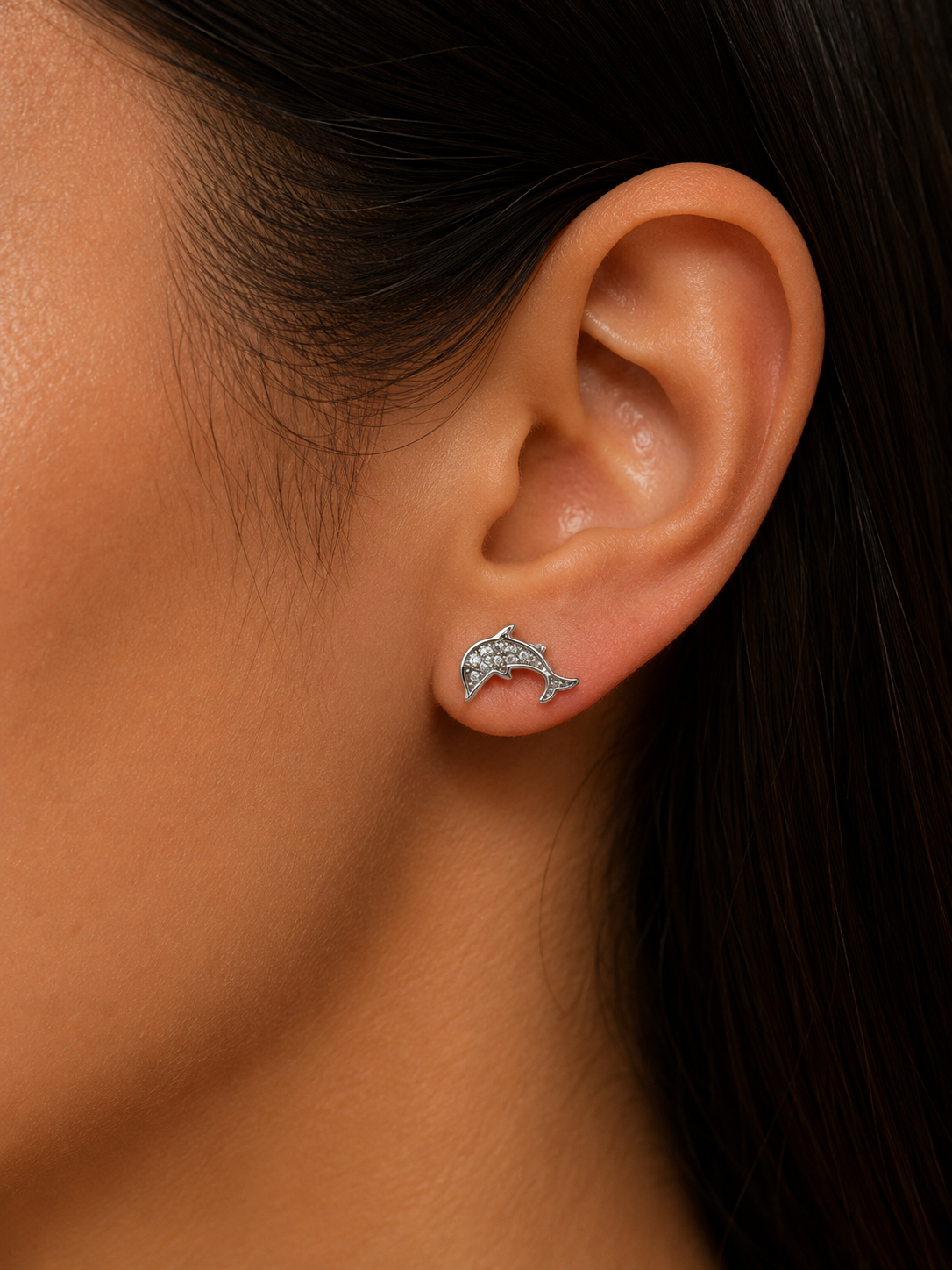 925 Sterling Silver Dolphin Stud Earrings shown in ear for size reference