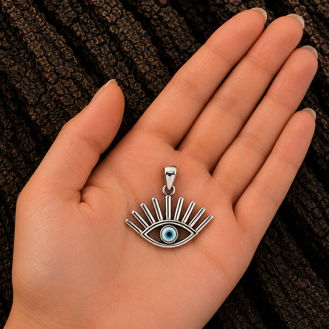 925 Sterling Silver Evil Eye Pendant shown in hand for size reference