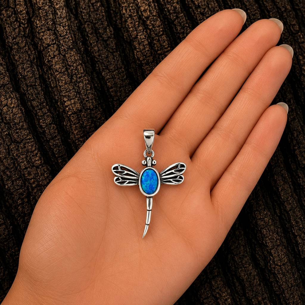 925 Sterling Silver Blue Lab Opal Dragonfly Pendant shown in hand for size reference