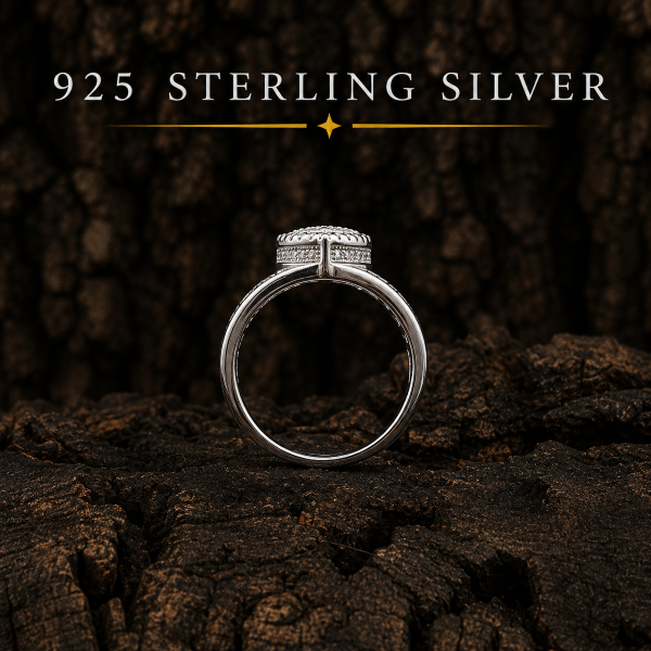 Silver ring with '925 Sterling Silver' text on a dark wooden background