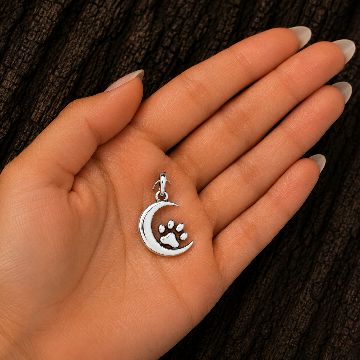 Sterling Silver Moon and Paw Print Pendant shown in hand for size reference