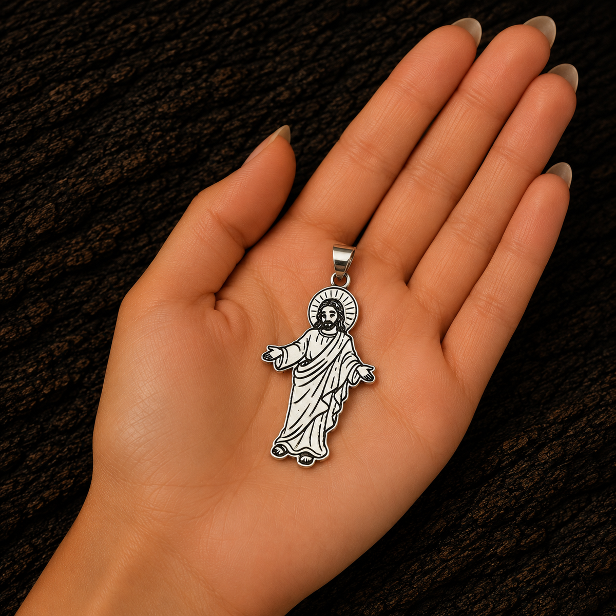 Jesus Christ 925 sterling silver pendant displayed in a woman’s hand to show its size and detailed craftsmanship.